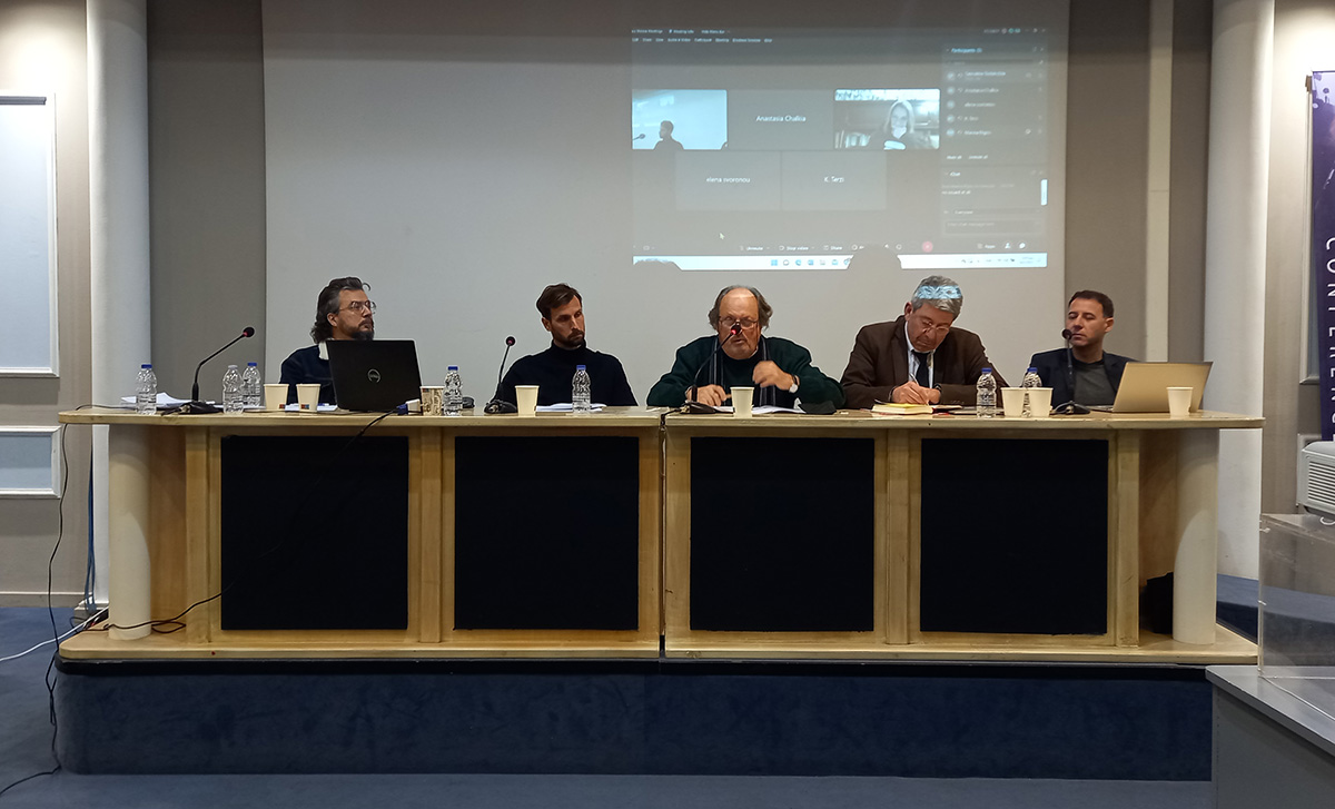 Panel of five persons behind a table on the podium.