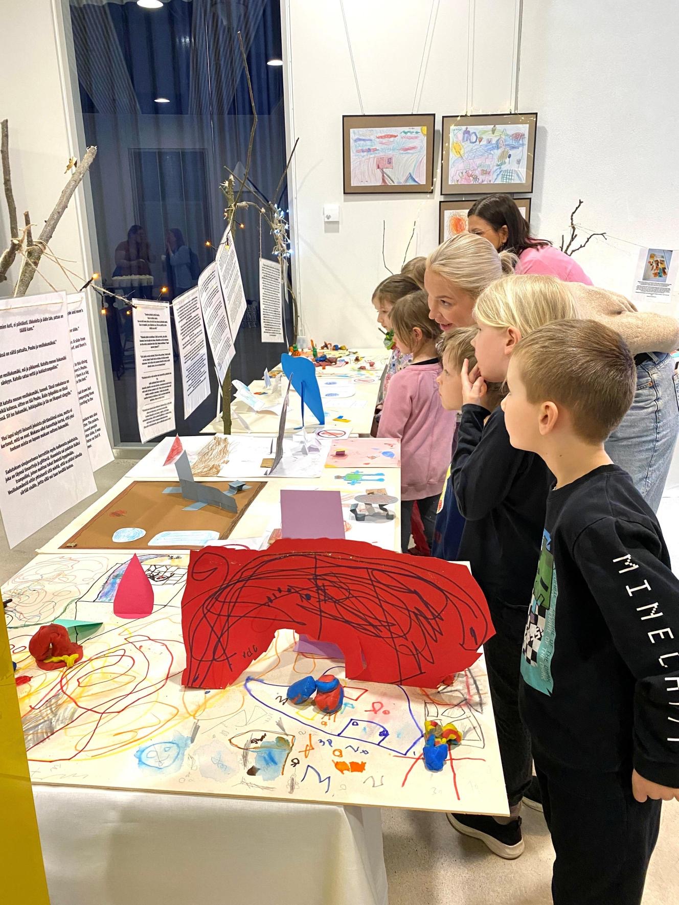 Children looking at their artwork of the daycare of dreams