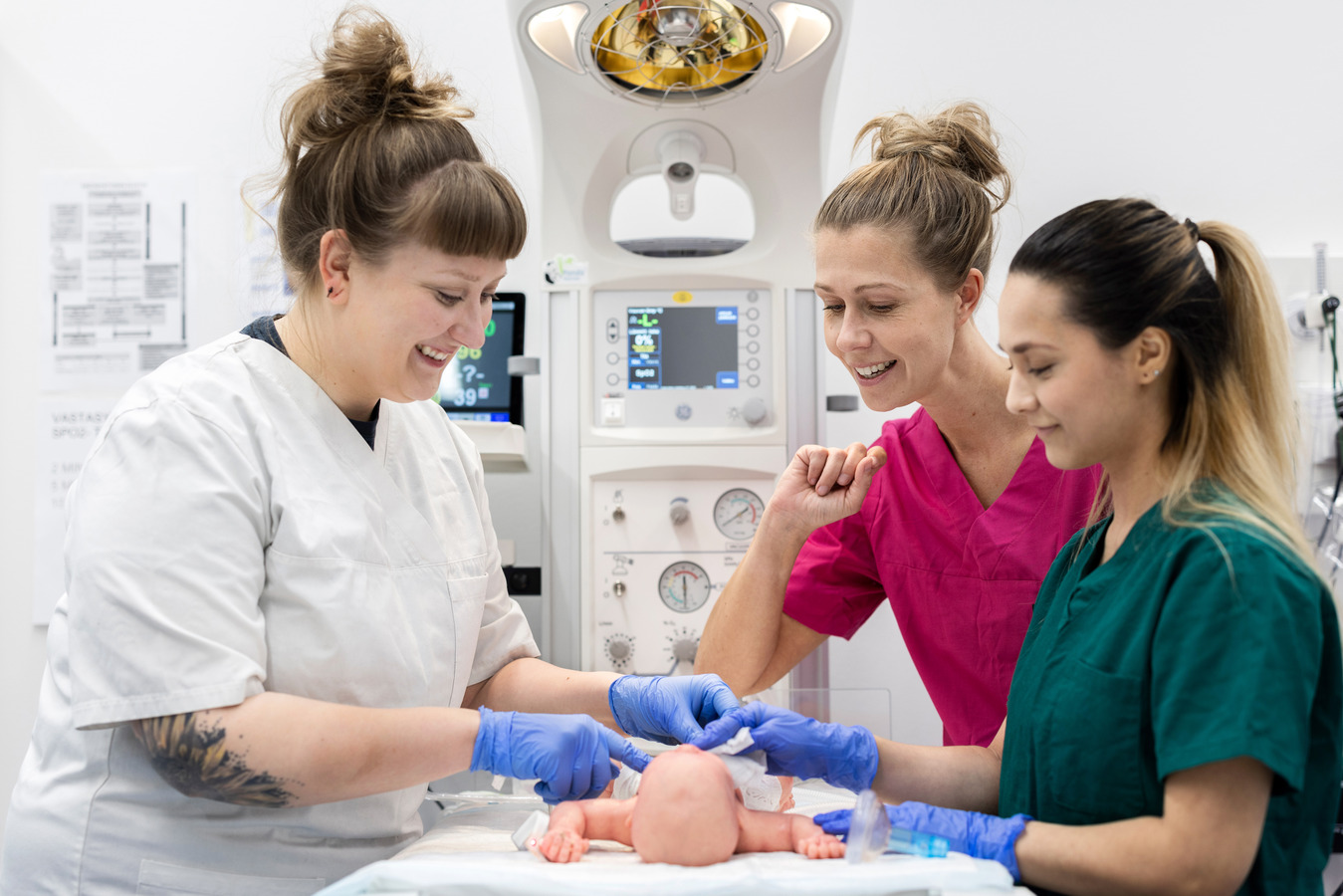 Two midwife students practicing with simulation baby.