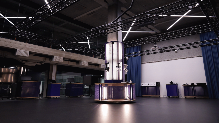 XR Showroom with dim light and VR-headsets hanging from the middle pillar.