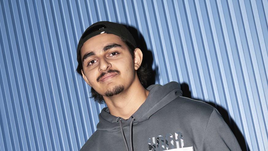 Young man leaning against the wall