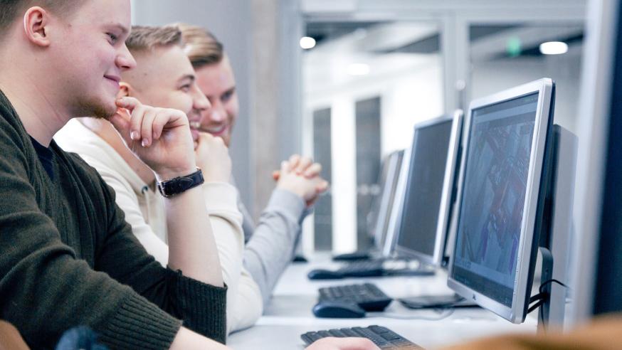 Three students working with computers.