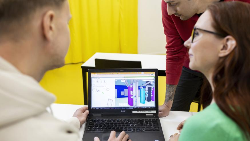 "Student working at a laptop on a computational model of a building"