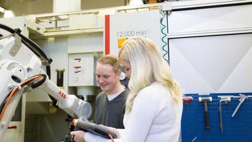 Two students in mechanical engineering lab.