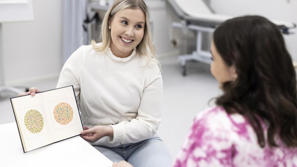 Nurse checking adults colorvision.