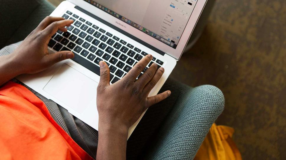 A student using a laptop.