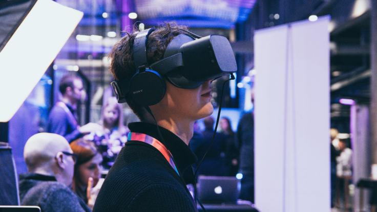 A person trying out virtual reality glasses.