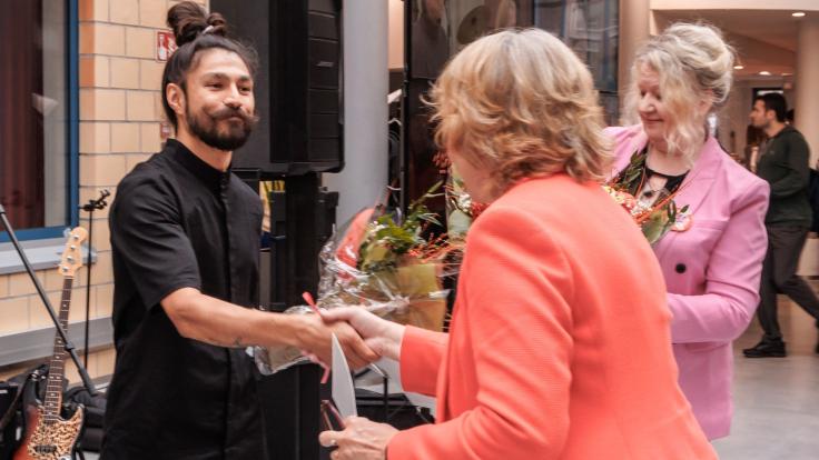 Designer Jesse Ukkonen being congratulated.