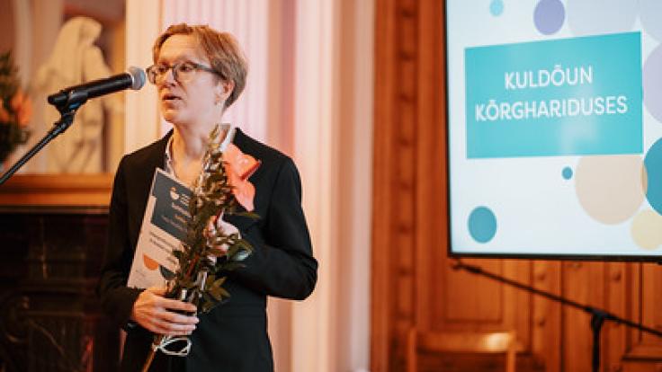 Eija Metsälä receiving award for a collaborative project.