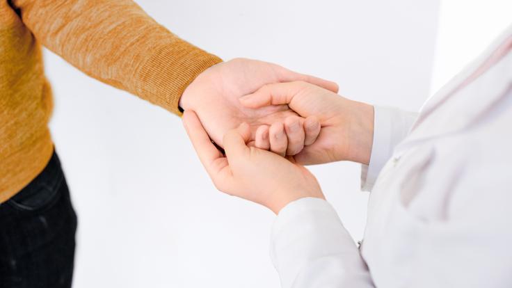 Person holding another's hand.