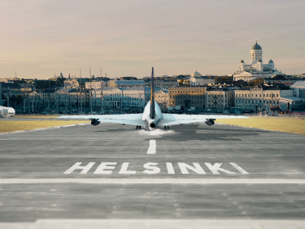 An airplane taking off, situated in middle of image, on ground text Helsinki, in the background cropped Helsinki city center skyline from the sea