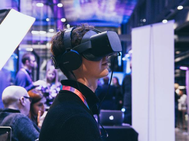 A person trying out virtual reality glasses.