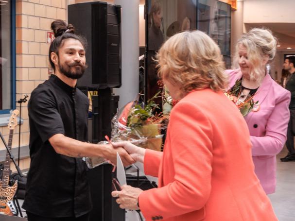 Designer Jesse Ukkonen being congratulated.