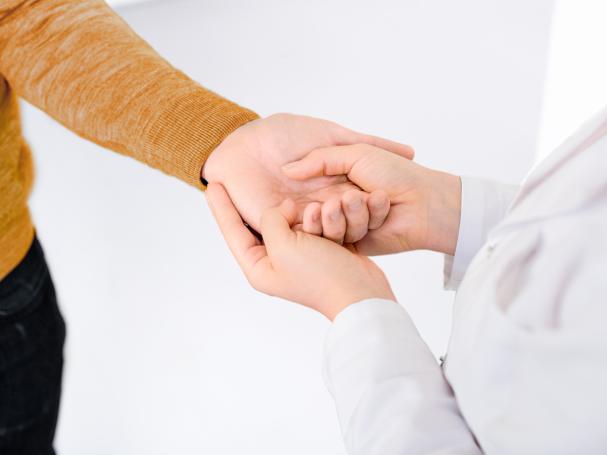 Person holding another's hand.