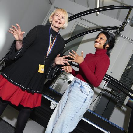 A student and a teacher smiling together
