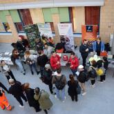 Students in the lobby of the Myyrmäki campus checking out the companies' stands.