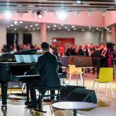 The pianist plays the grand piano