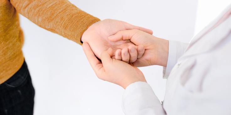 Person holding another's hand.
