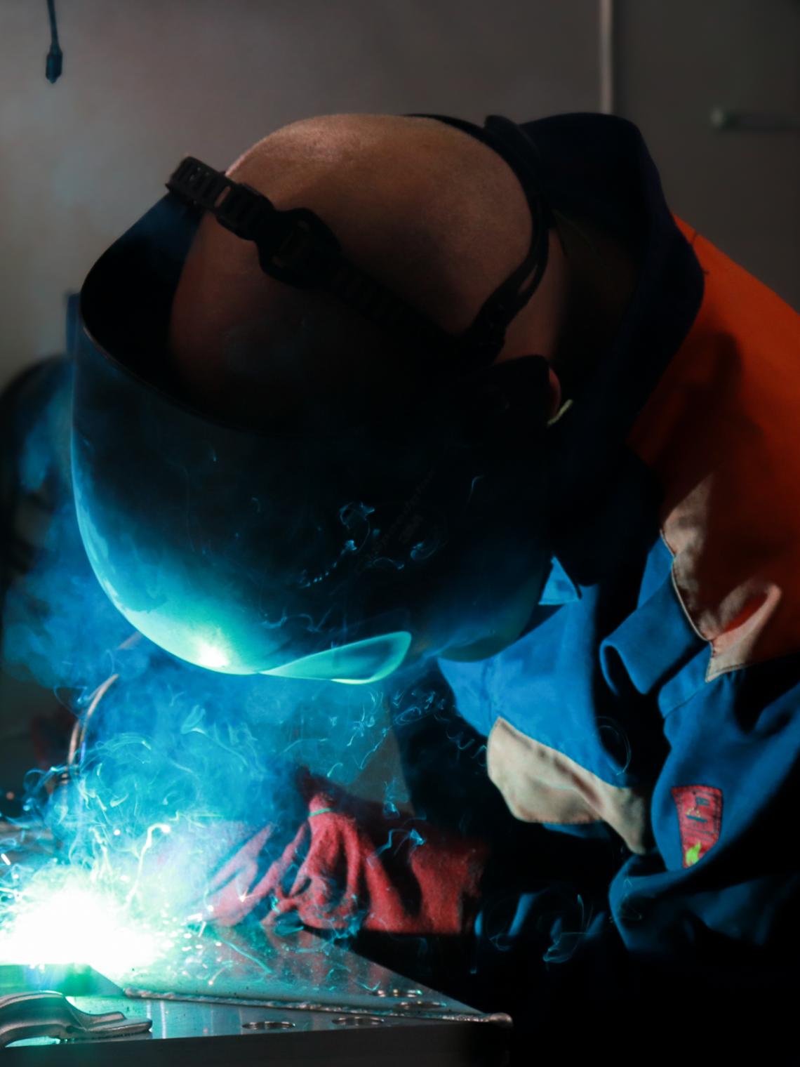 Student is welding with a welding mask on
